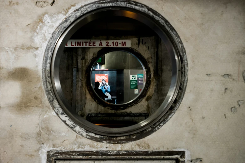 a public bathroom is seen through a circular window