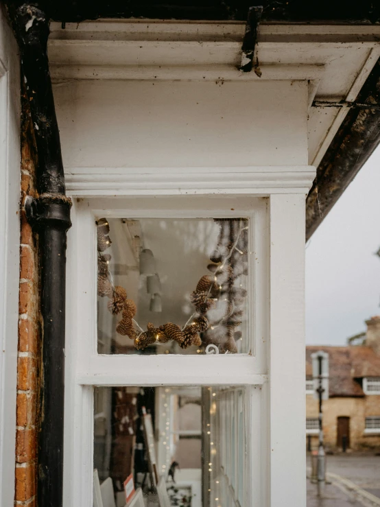 a view from inside a window of buildings and outside a store