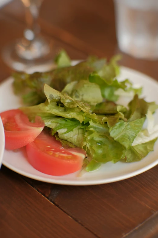 a white plate topped with salad and water