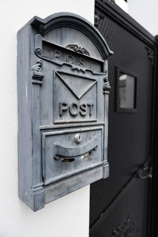 a letterbox attached to a wall mounted mailbox