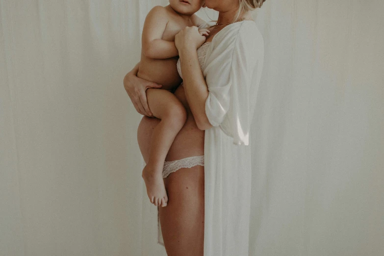 a woman and child are kissing