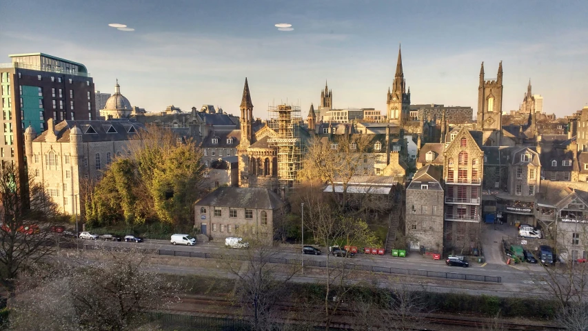 a city skyline from a distance overlooking the street and tracks