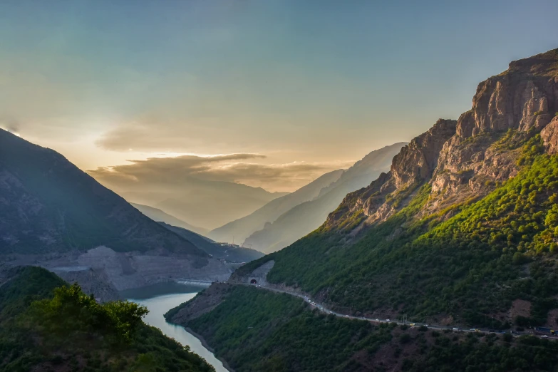 the mountains surrounding a river in the distance