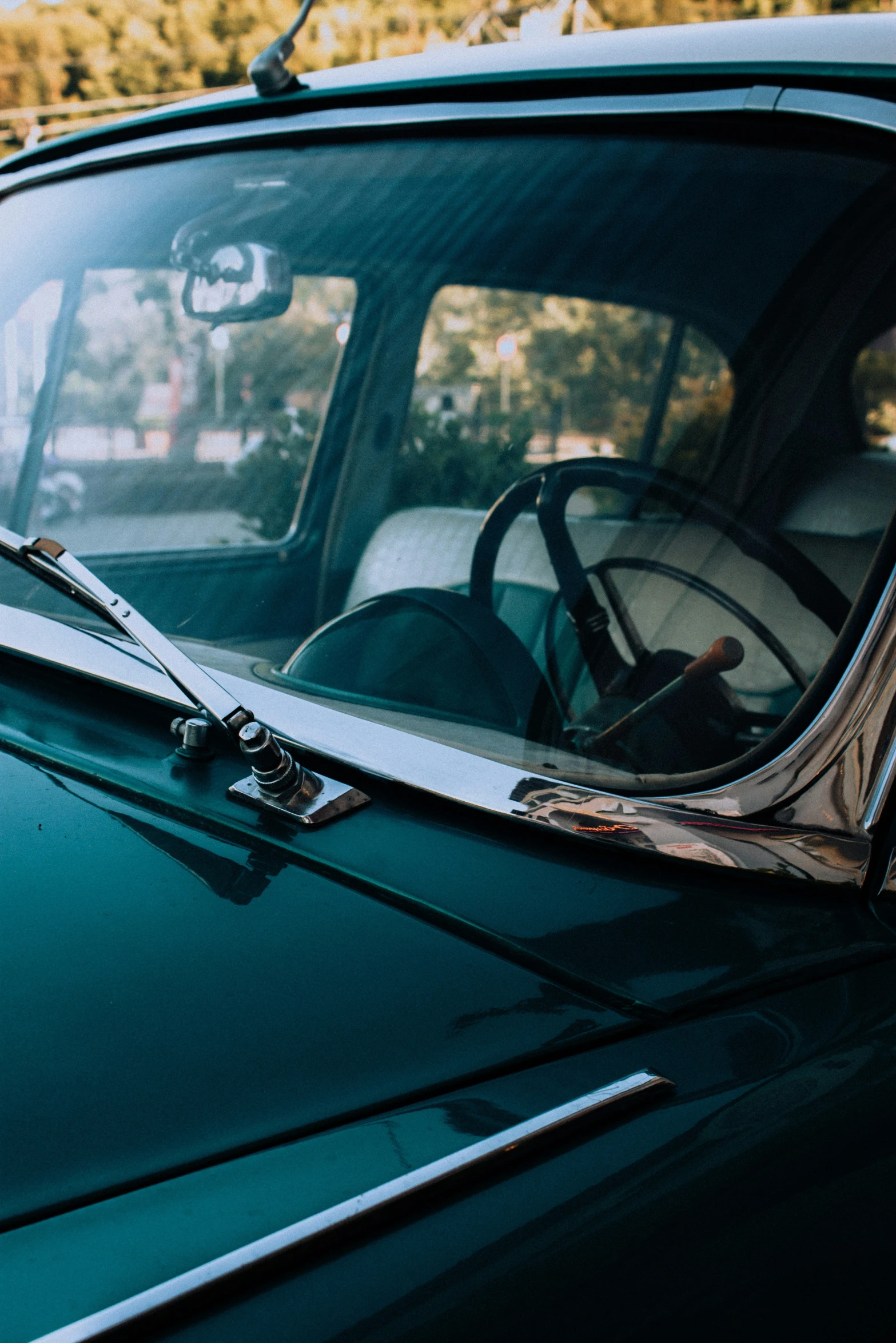 the side view mirror of an old car with a long stem sticking out the window