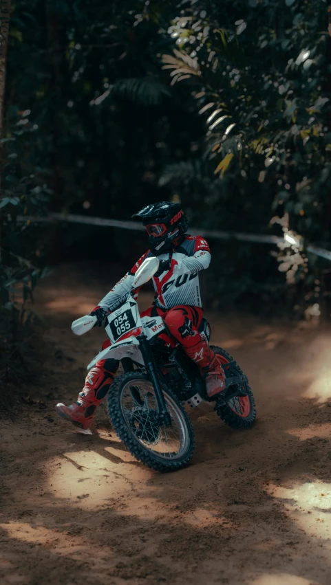 a dirt bike rider is racing on the road