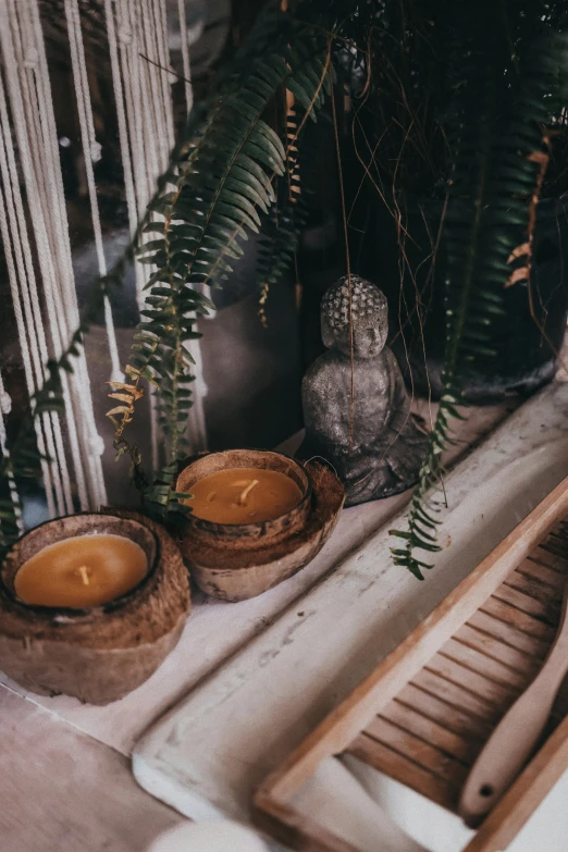 a table topped with three wooden bowls and candles