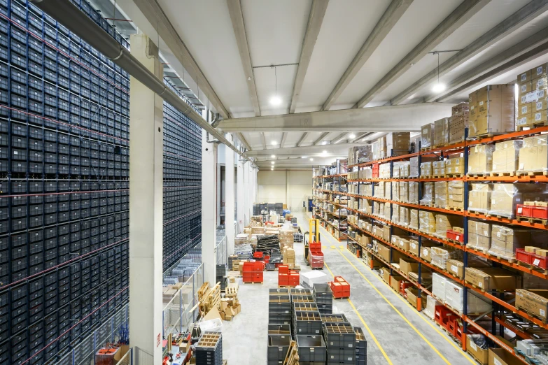 a large room with multiple racks of blue boxes