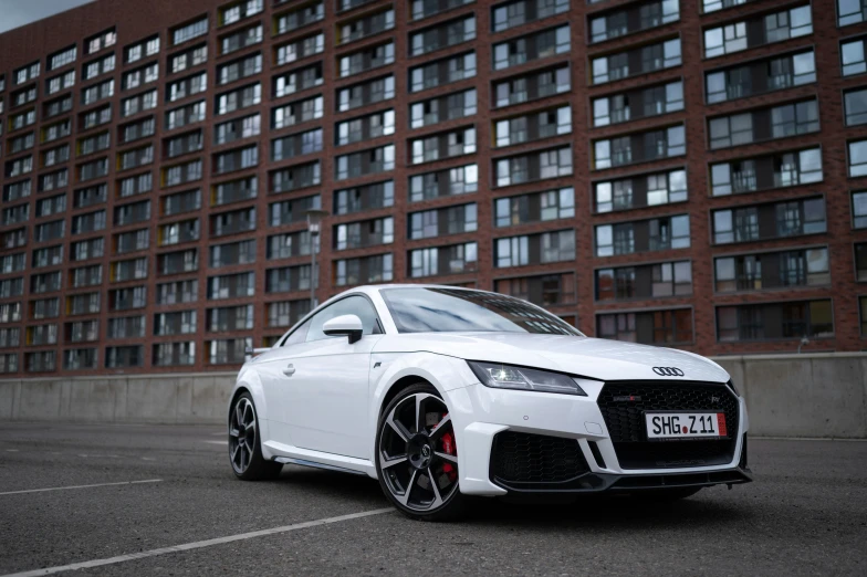 an white car in front of a red brick building