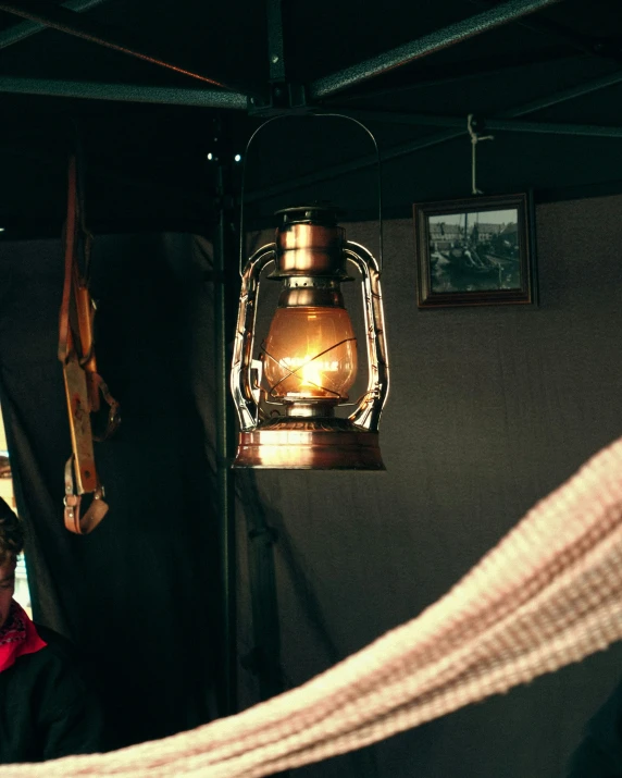 a woman and man are in front of a small lantern