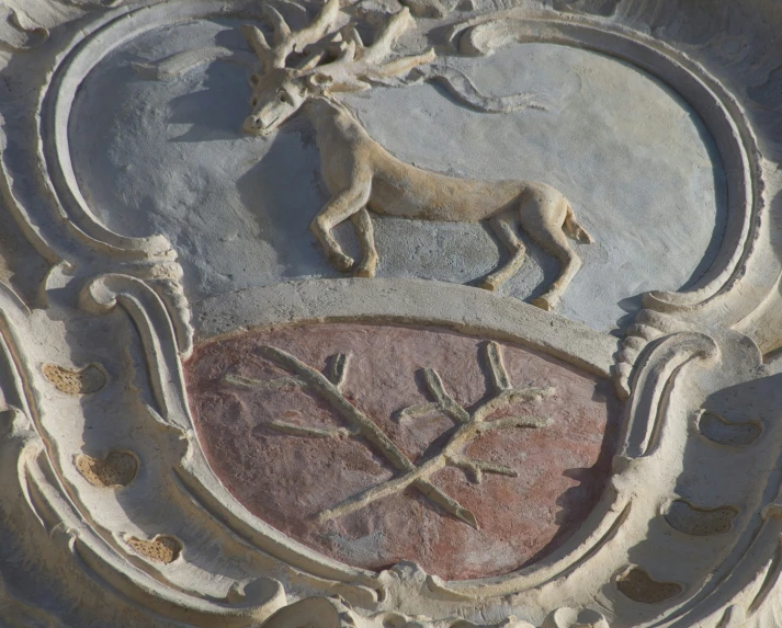 a coat of arms with two horses next to it