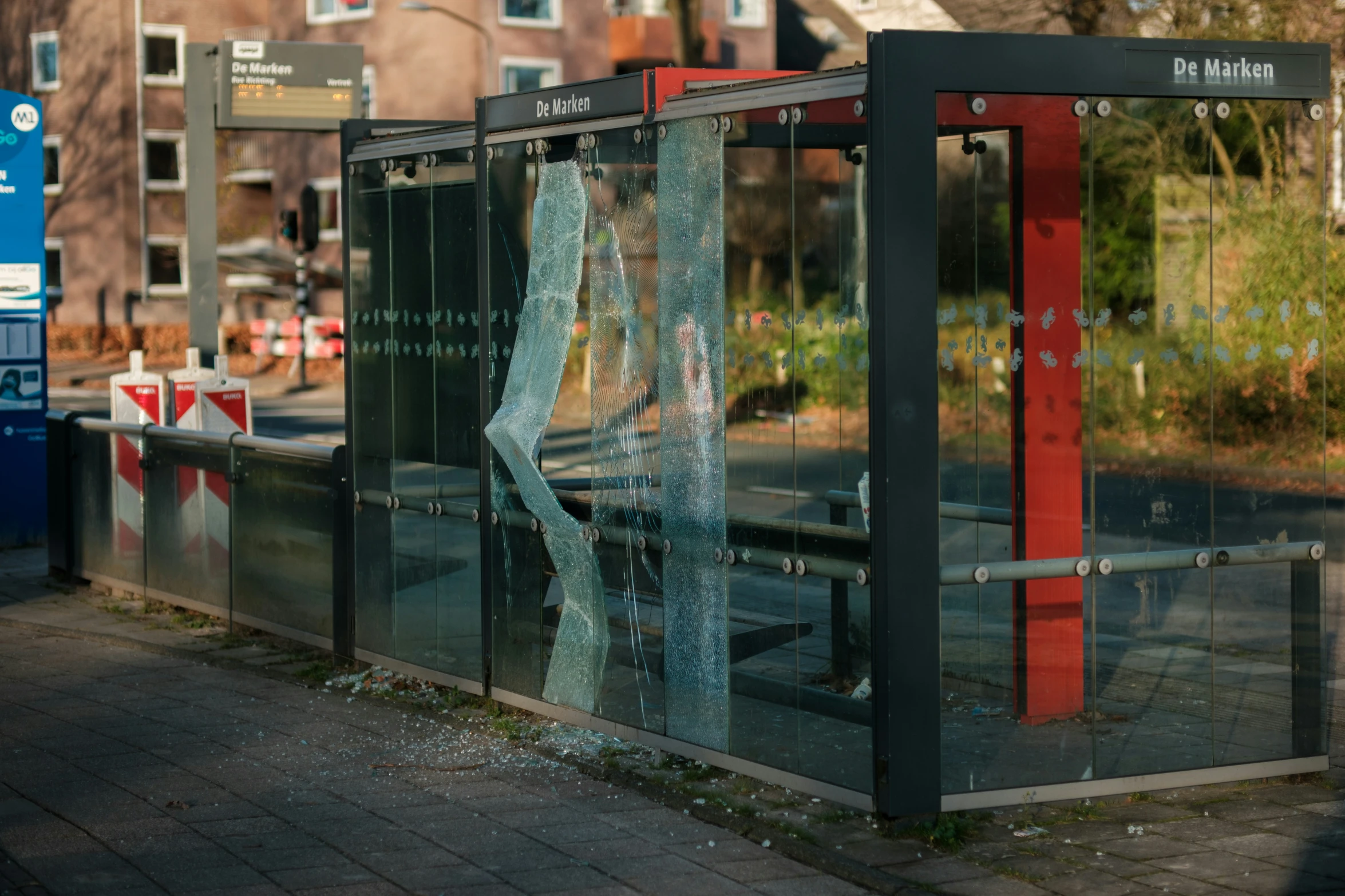 the shattered out door of a bus stop