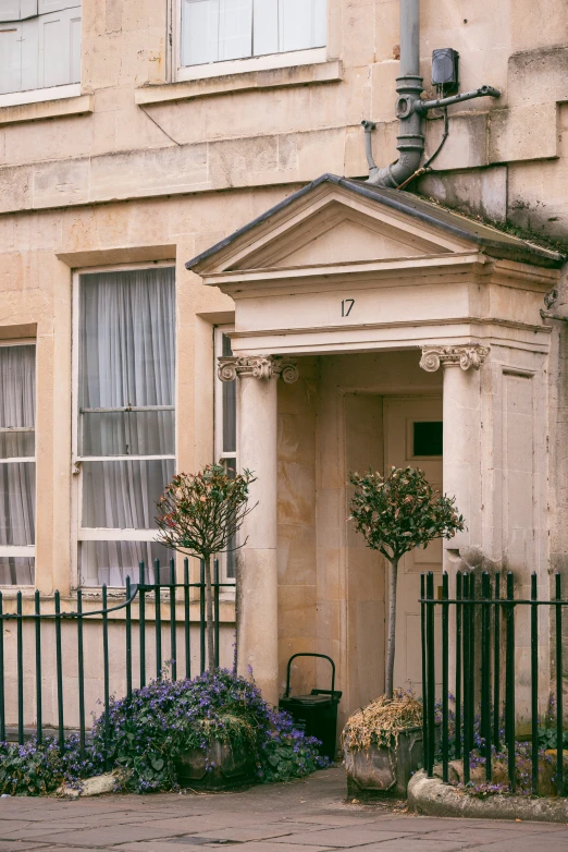 a stone building with a bunch of flowers growing in the front