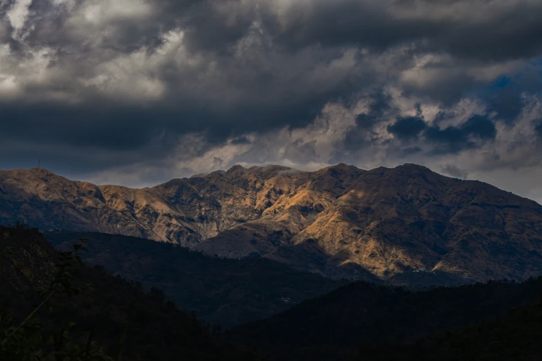 dark mountains sit in the background as clouds fill the sky