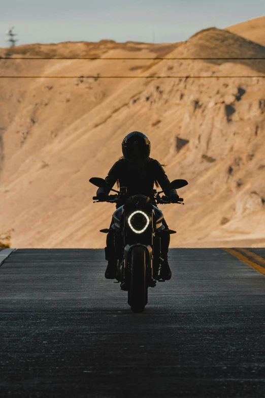 the person is riding a motorcycle on a road