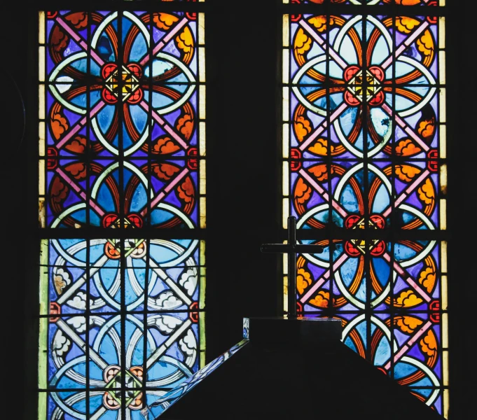two stained glass windows in front of each other