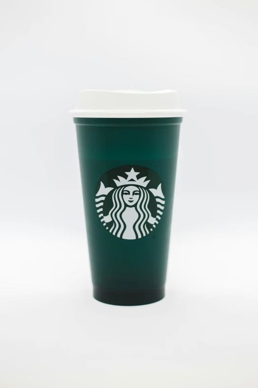 the starbucks cup is shown with white cap