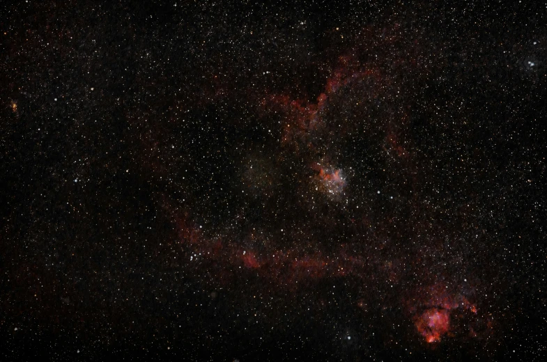 a cluster of stars in the sky over a dark background