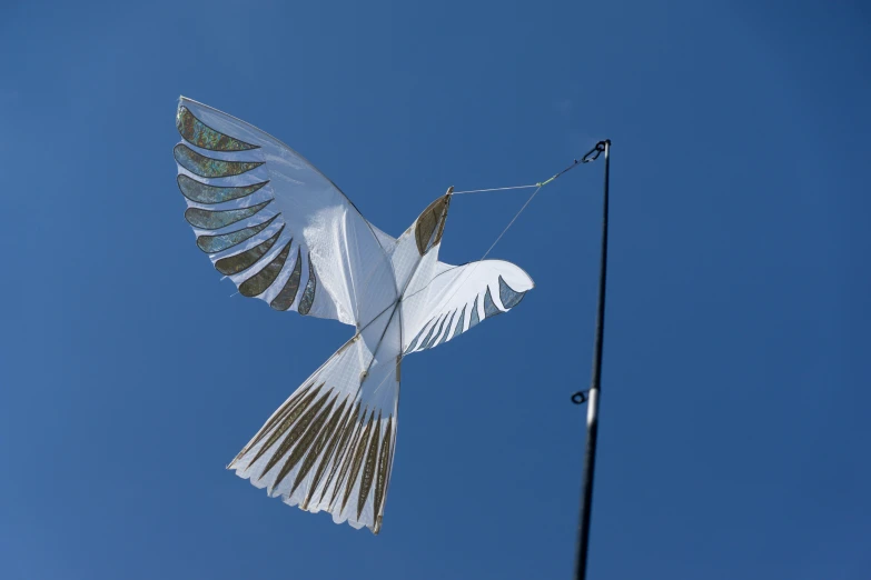 two doves flying next to a light pole