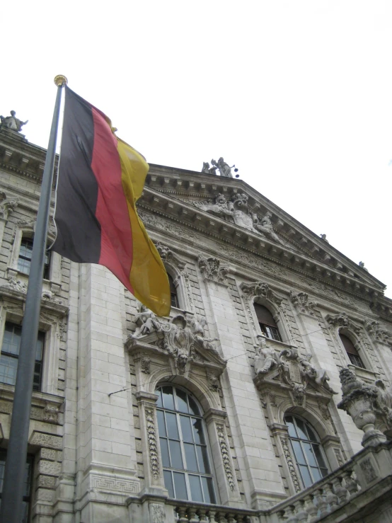 a large flag next to a tall building