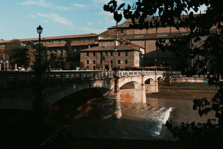 a large bridge over a river in front of a city