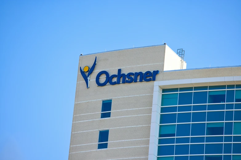 an office building on a sunny day with the voucher logo above