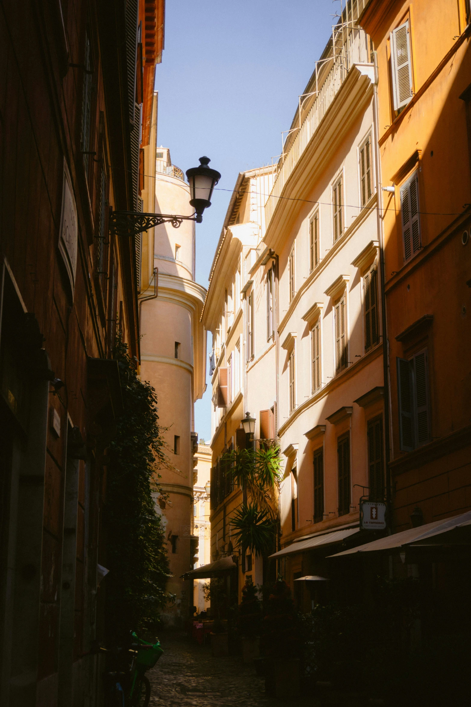 street in a city with the sun shining through windows