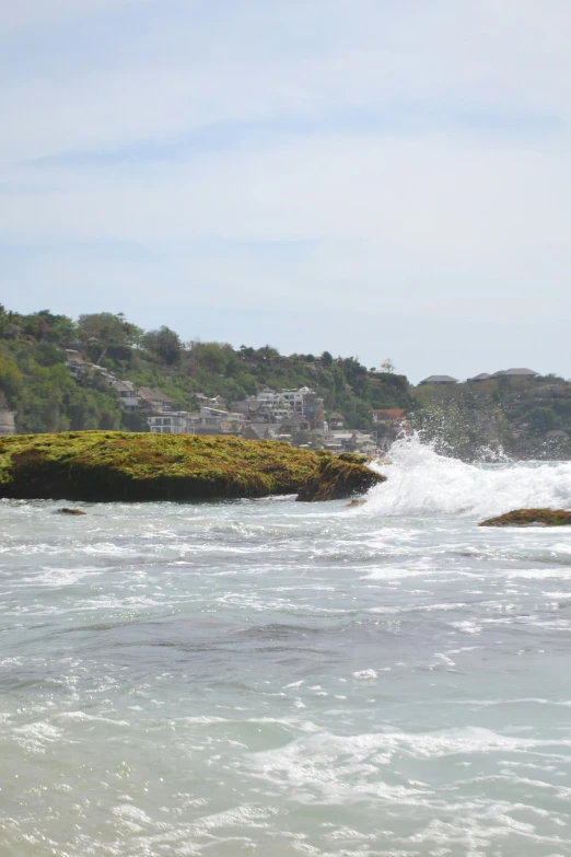 a person rides a surfboard on a body of water