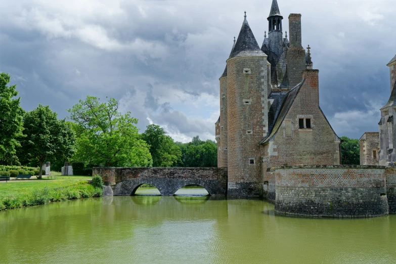 an old castle with a river underneath it