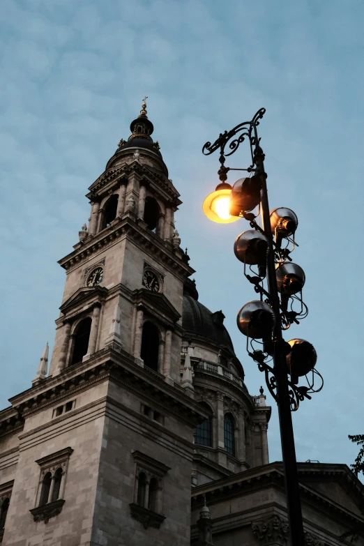 light up and a lamp with the tops of buildings in the background