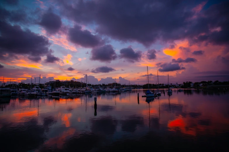 a harbor filled with lots of boats under a cloudy sky