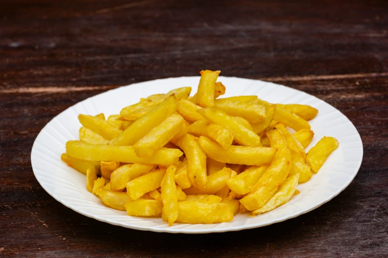 a white plate topped with yellow fries