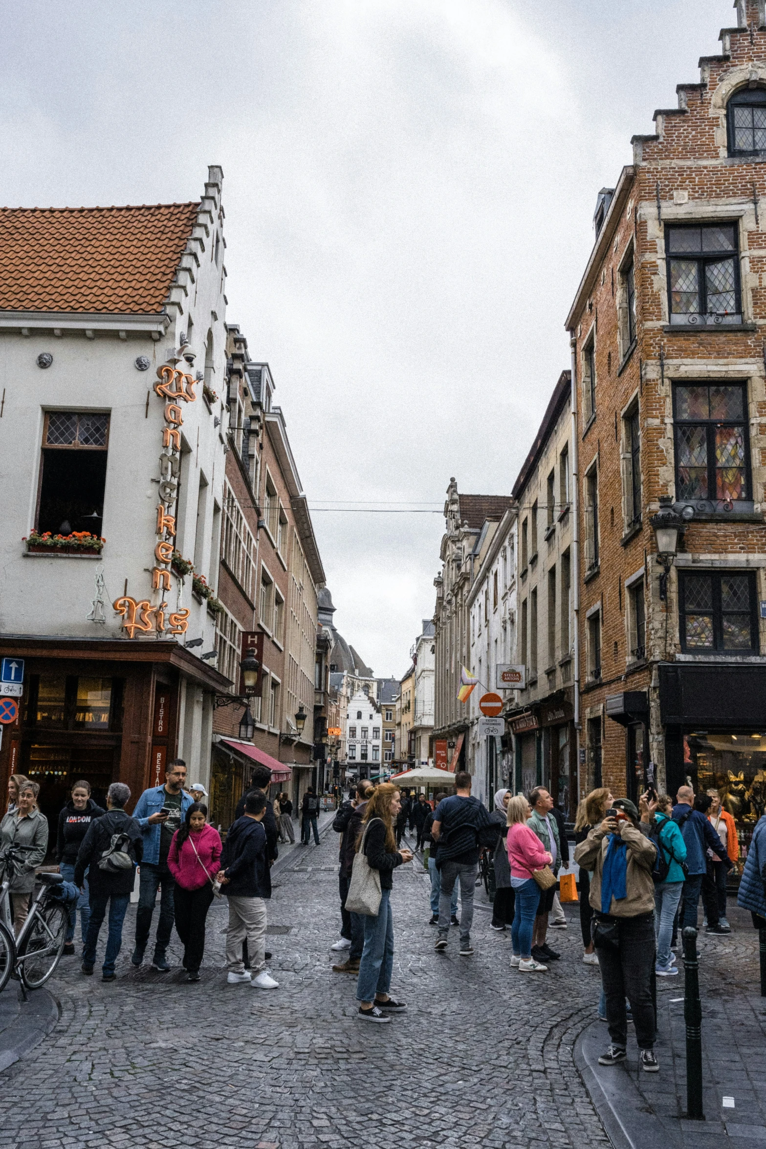 a city street has various people walking in it