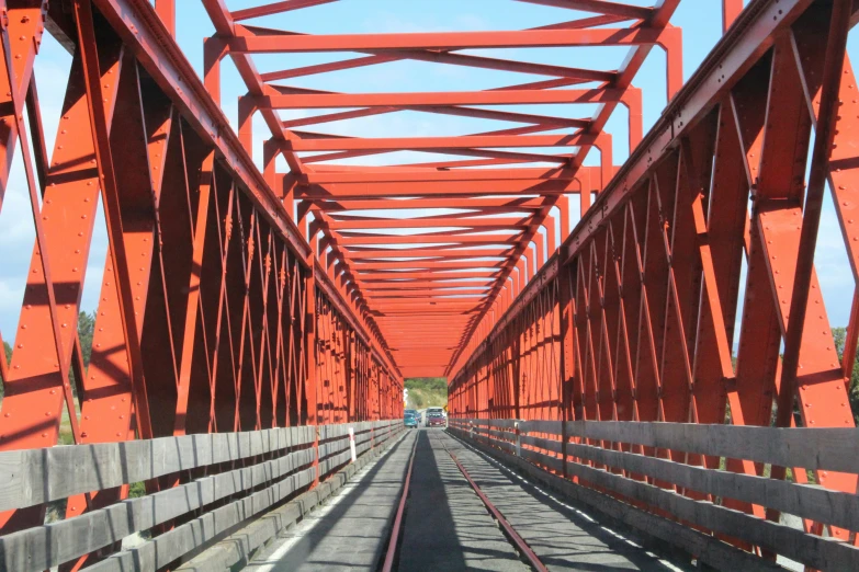 the view from the far end of an orange bridge