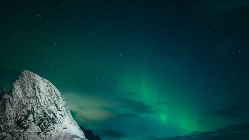 the aurora bore as seen above a snowy mountain