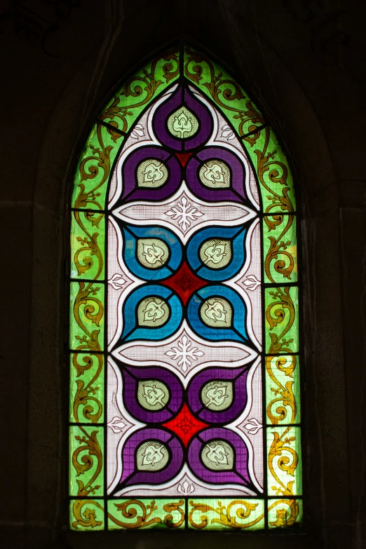 a stained glass window in the middle of a room