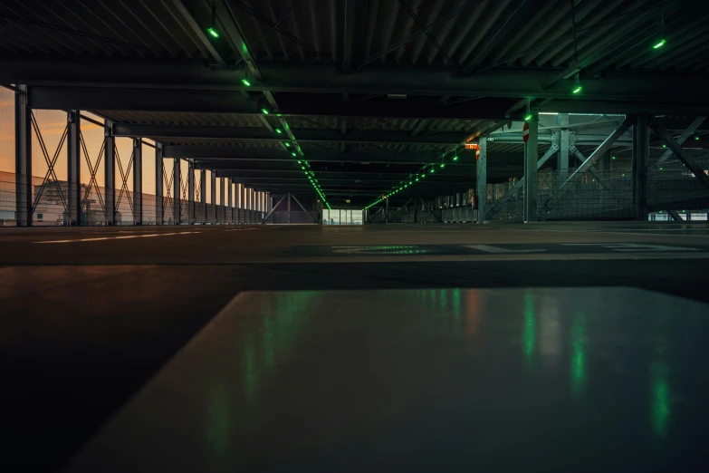 an empty parking garage with only lights visible