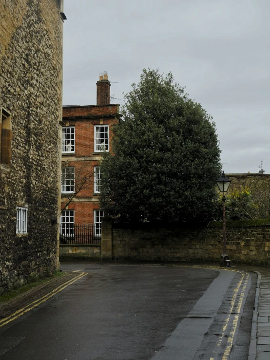 an empty street between two large brick buildings