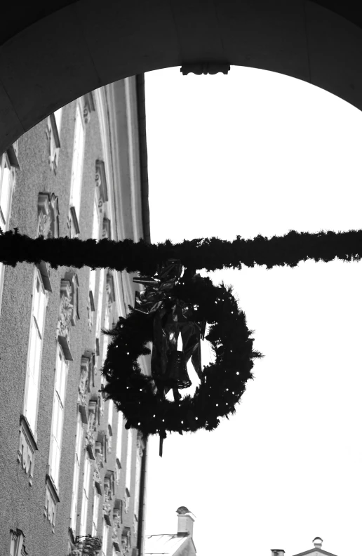 a couple of people in front of a building with a wreath