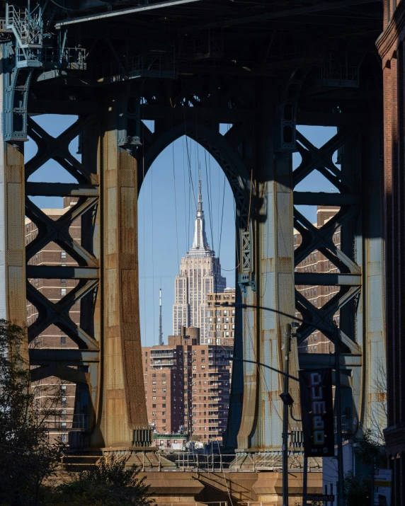 a view of a bridge from across the river with tall buildings in the background