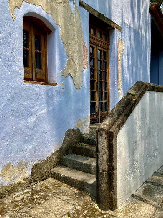 an old, rundown building with broken windows