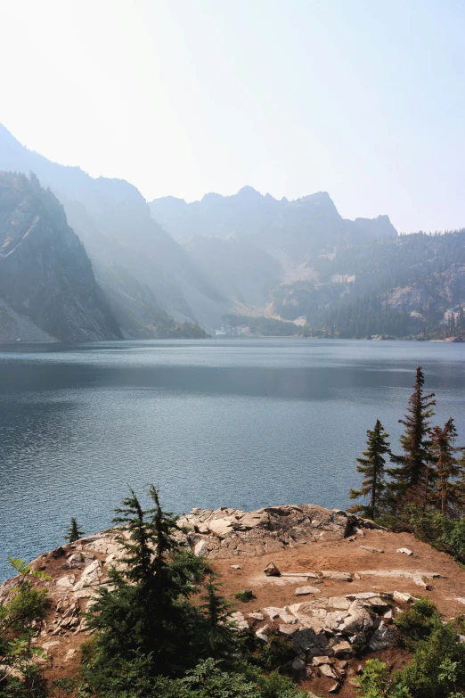 an expansive lake with some rocks on the ground