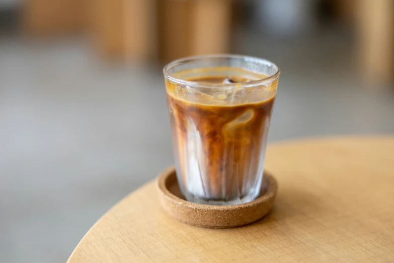 an iced beverage is on a round table