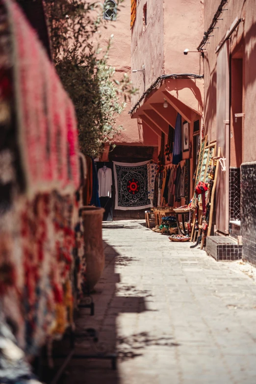 a narrow alley with a variety of colorful items