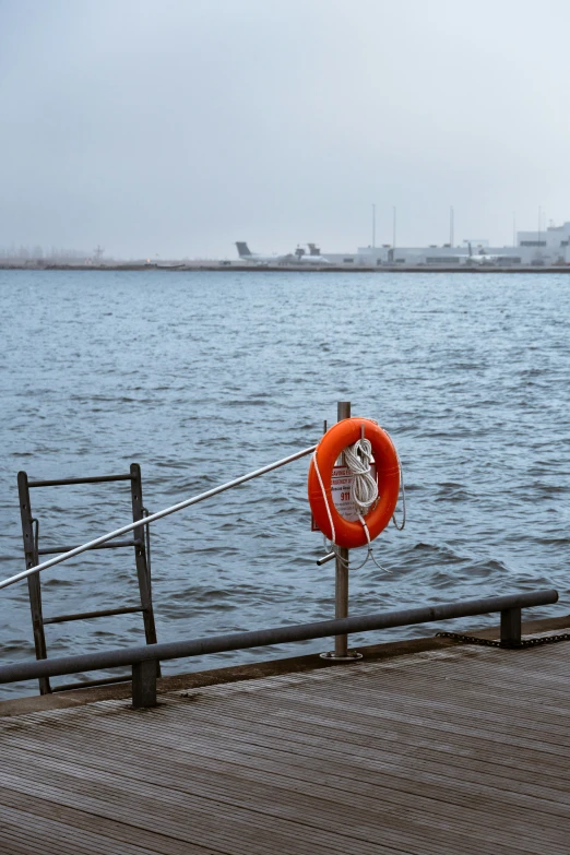 a life preserver is on a wooden pole at the dock