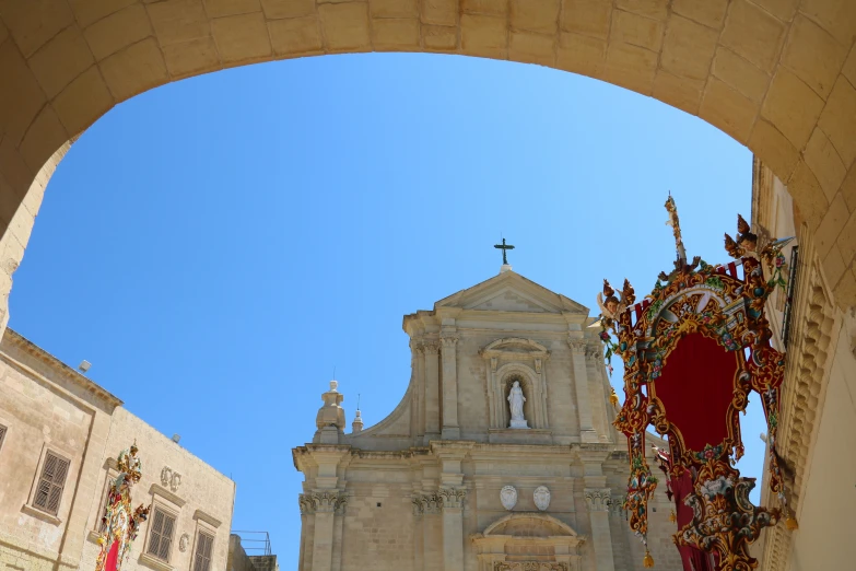 an archway leading to a church with decorative decorations