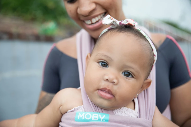 a lady holding a baby in her arms