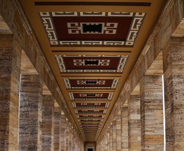 a corridor with decorative brickwork and gold columns