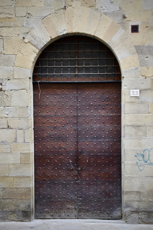 a brown door with brick arches at the bottom