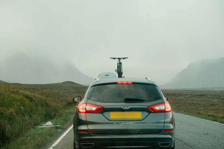 the back view of a car parked on a road