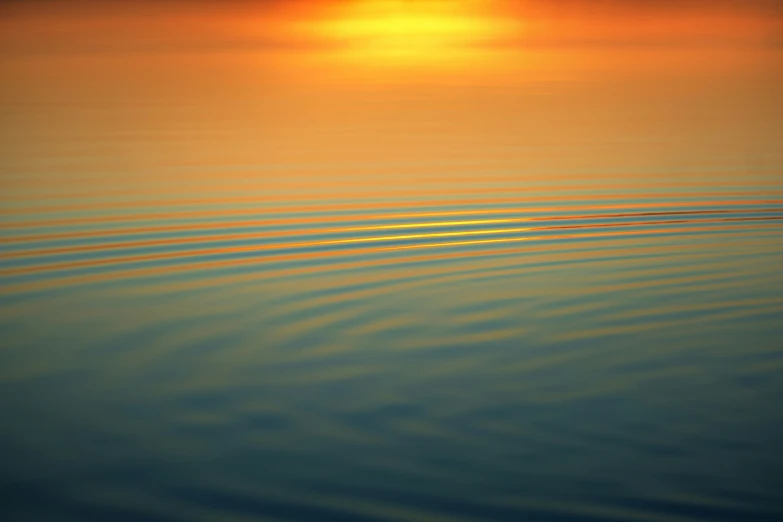 a boat floating in water with the sun shining